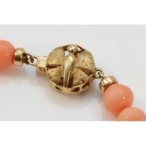 597 - A 9ct gold coral bead bracelet, 21cm, 12.5g