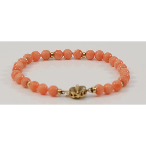 597 - A 9ct gold coral bead bracelet, 21cm, 12.5g