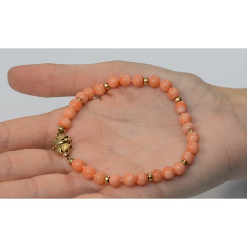 597 - A 9ct gold coral bead bracelet, 21cm, 12.5g