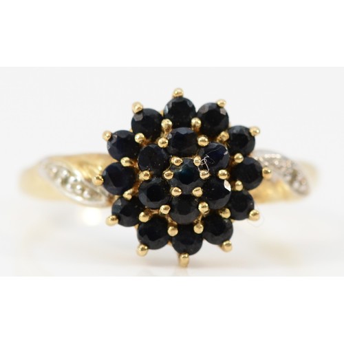 599 - A 9ct gold sapphire cluster ring with diamond set shoulders, 10mm ring front, P, 2.5g