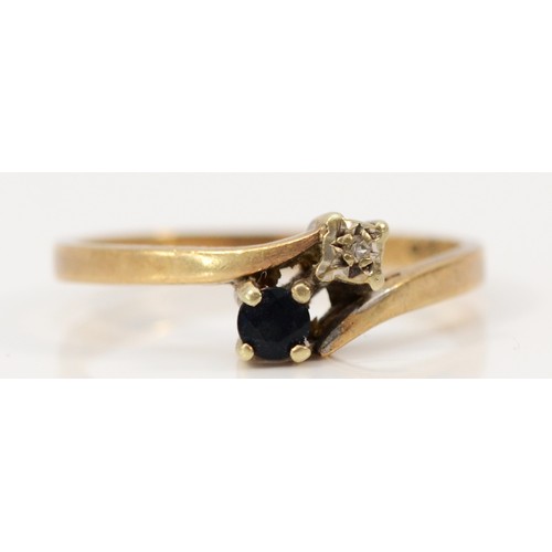 609 - A 9ct gold diamond and sapphire cross over ring, L, 1.5g