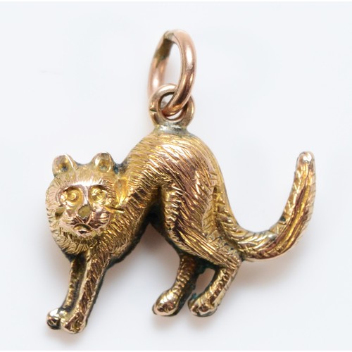 610 - A 9ct gold charm in the shape of a cat, 15mm across, 0.6g