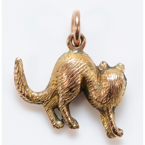 610 - A 9ct gold charm in the shape of a cat, 15mm across, 0.6g