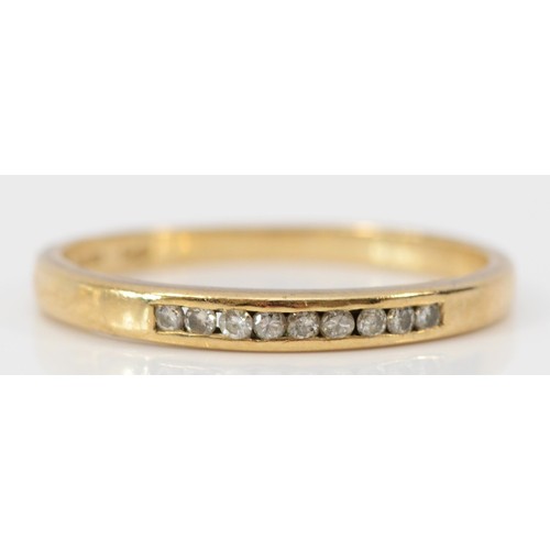 612 - A 9ct gold nine stone brilliant cut diamond channel set ring, O, 1.4g