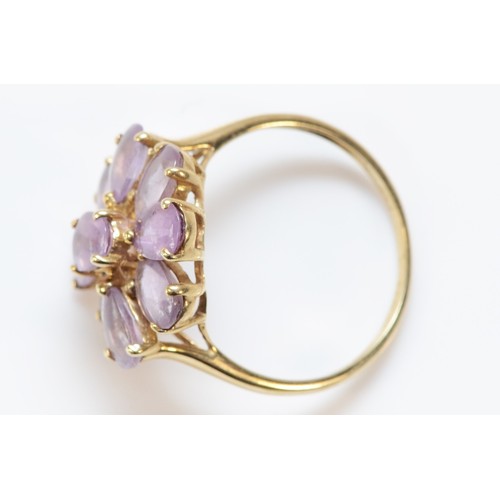 616 - A 9ct gold amethyst floral cocktail ring, 18mm ring front, O, 2.7g