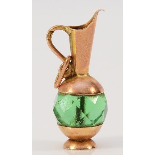 621 - A 9ct gold vintage emerald paste charm in the shape of a pitcher, 25mm total length, 2.2g