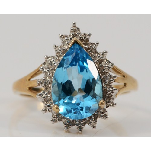 625 - A 9ct gold pear cut blue topaz and diamond dress ring,12mm topaz length, P, 3.2g