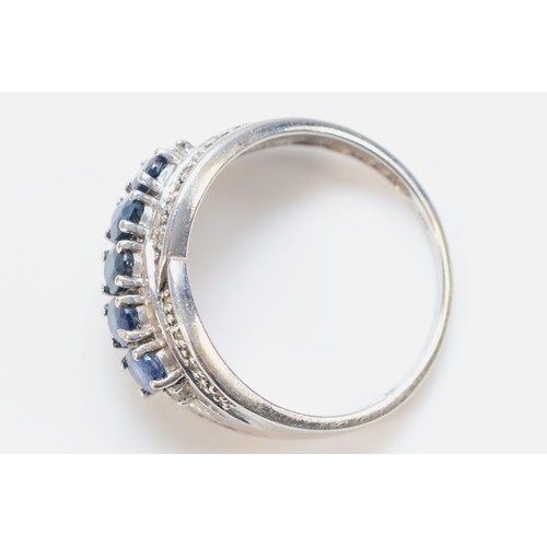 648 - A 9ct white gold sapphire and diamond dress ring, O, 3.5g