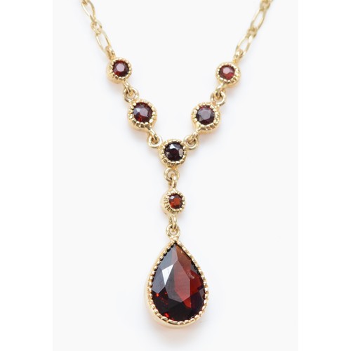 650 - A 9ct gold pear cut garnet necklace, 2.8g