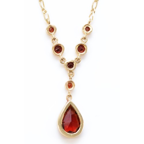 650 - A 9ct gold pear cut garnet necklace, 2.8g