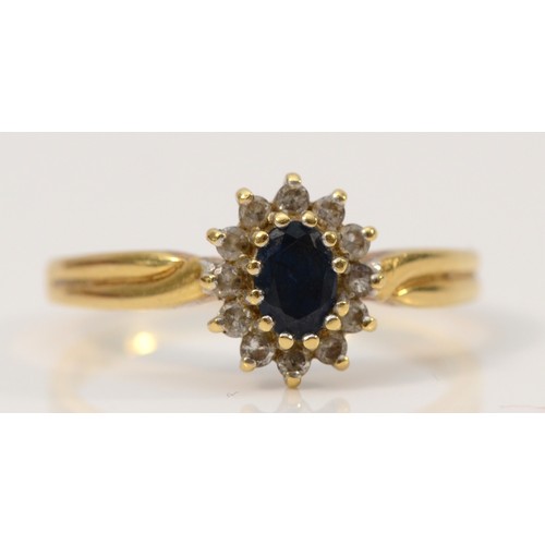 659 - A 14K gold sapphire and diamond cluster ring, 5mm sapphire, T 1/2, 3.8g