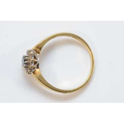 659 - A 14K gold sapphire and diamond cluster ring, 5mm sapphire, T 1/2, 3.8g