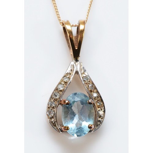 661 - A 9ct gold oval cut blue topaz and diamond pendant with chain, 7mm x 5mm topaz, 1.4g