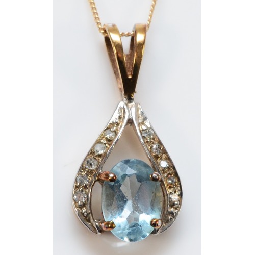 661 - A 9ct gold oval cut blue topaz and diamond pendant with chain, 7mm x 5mm topaz, 1.4g