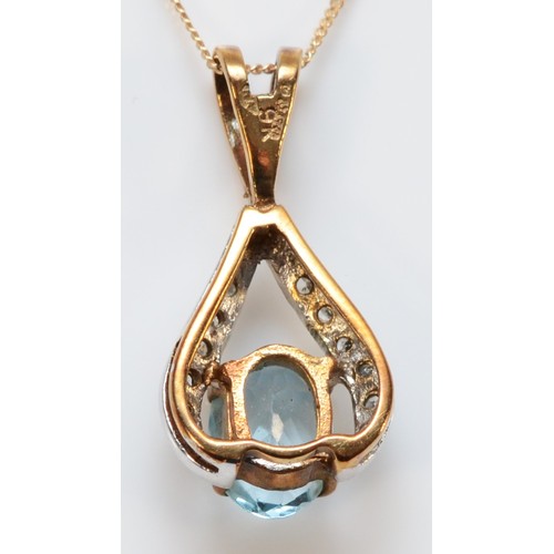 661 - A 9ct gold oval cut blue topaz and diamond pendant with chain, 7mm x 5mm topaz, 1.4g