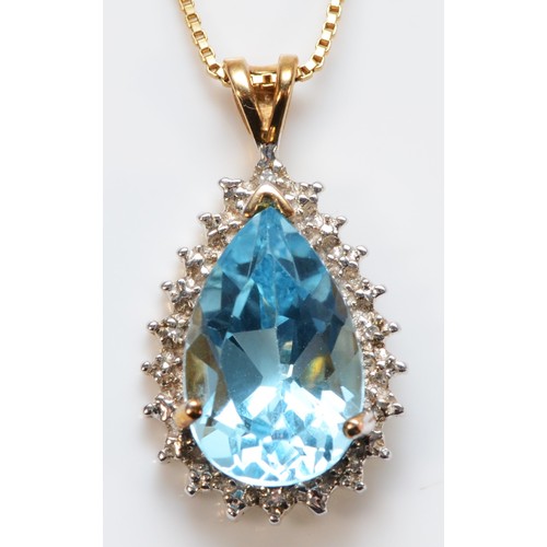 665 - A 9ct gold pear cut blue topaz and diamond cluster pendant, 15mm topaz length, 4g