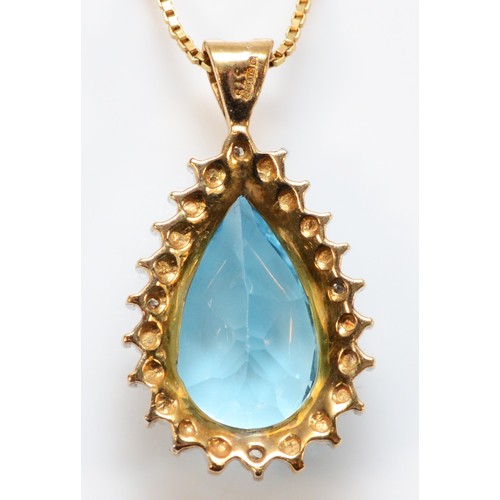 665 - A 9ct gold pear cut blue topaz and diamond cluster pendant, 15mm topaz length, 4g