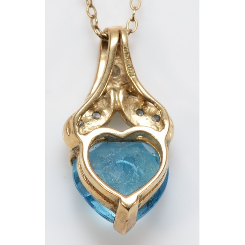 666 - A 9ct gold heart cut blue topaz and diamond pendant, 20mm total pendant length, 3.2g