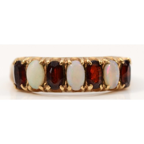 673 - A 9ct gold opal and garnet dress ring, R, 3g