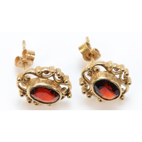 675 - A pair of 9ct gold garnet earrings with scroll backs, 13mm, 1.8g