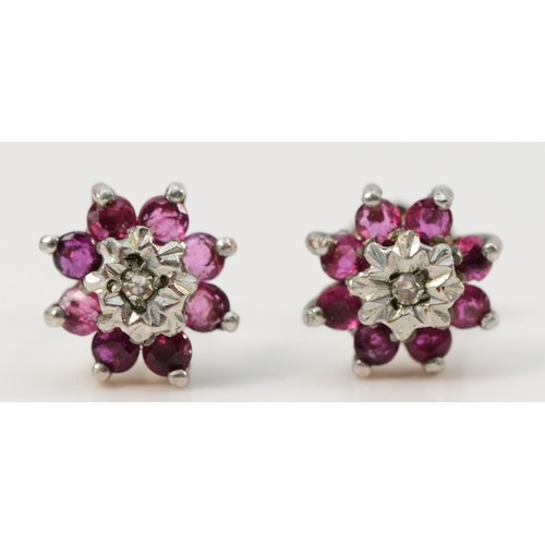 677 - A pair of 9ct gold diamond and ruby flower cluster earrings, 7mm, 1g