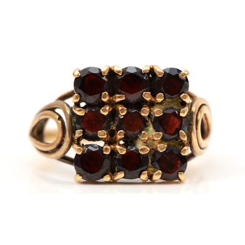 699 - A 9ct gold vintage garnet dress ring, 10mm ring front, K 1/2, 3.5g