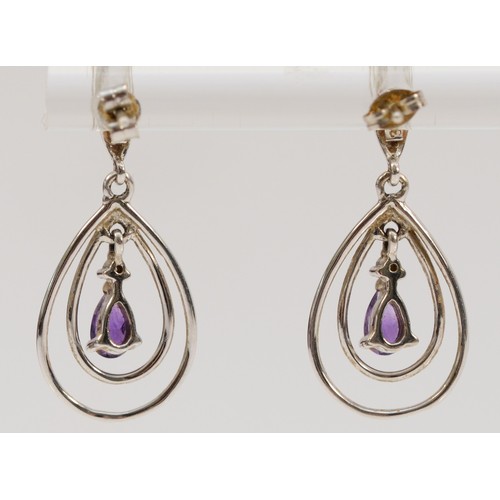 705 - A pair of 9ct white gold pear cut amethyst and diamond drop earrings with scroll backs, 23mm drop, 1... 