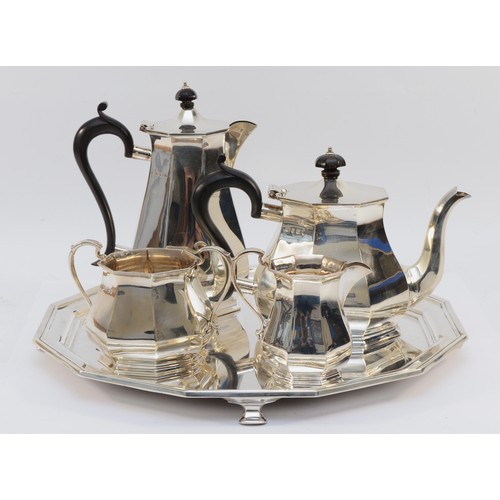 A silver four piece tea and coffee service, by Roberts & Belk, Sheffield 1932, of octagonal form, together with a matching tray, by Atkin Bros, Sheffield 1932, diameter 36cm, combined weight 99oz.