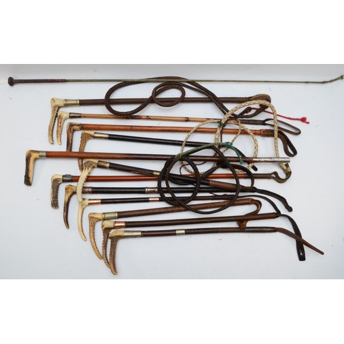 128 - A collection of mid 20th century and later riding crops and whips, to include coiled whips having pl... 