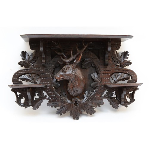 134 - A carved wood wall bracket, probably Bavaria, with central stag surrounded by three shelves, 61 x 42... 