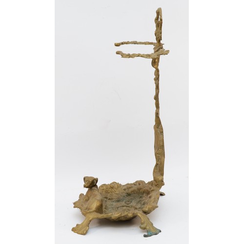 141 - A cast brass stick stand, with hunting horn, shotgun and hound, raised on a naturalistic ground, 56c... 