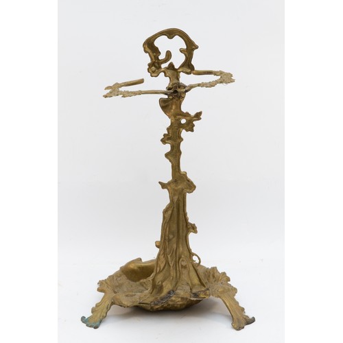 141 - A cast brass stick stand, with hunting horn, shotgun and hound, raised on a naturalistic ground, 56c... 