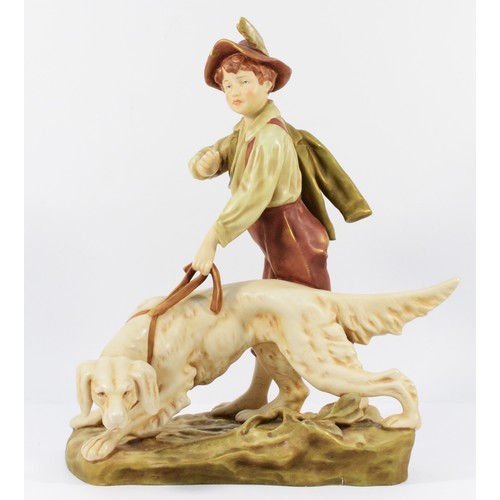 143 - A Royal Dux Bohemia ceramic figurine, depicting a young boy with a hunting dog, 34 x 23cm.