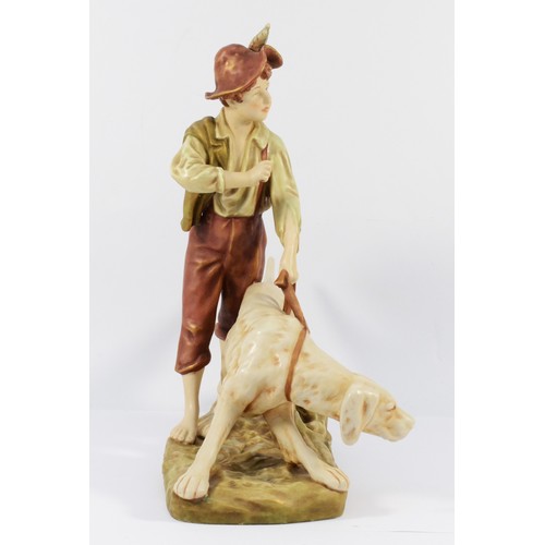 143 - A Royal Dux Bohemia ceramic figurine, depicting a young boy with a hunting dog, 34 x 23cm.