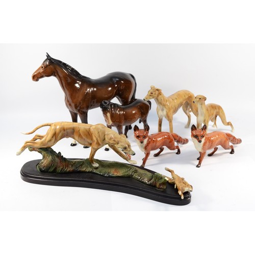 145 - Four Beswick ceramic models, to include, two standing foxes and two brunette standing horses, togeth... 