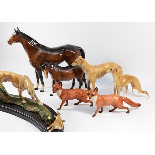 145 - Four Beswick ceramic models, to include, two standing foxes and two brunette standing horses, togeth... 