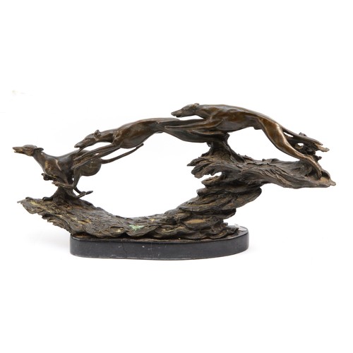 152 - A bronze sculpture depicting three leaping hunting dogs, H-25cm x 53.