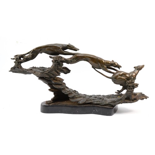 152 - A bronze sculpture depicting three leaping hunting dogs, H-25cm x 53.