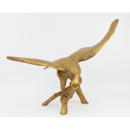 158 - A brass sculpture of an eagle on a branch, unsigned, wing span 64cm