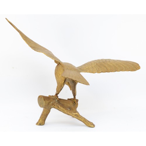 158 - A brass sculpture of an eagle on a branch, unsigned, wing span 64cm