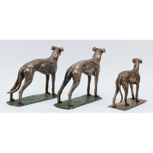 164 - A pair of metal greyhounds on green painted bases, one lacking his tail, height 14cm and another sim... 