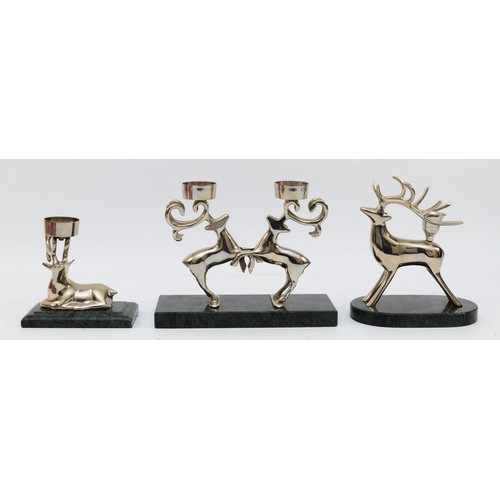 165 - A pair of chrome plated rutting reindeer candlestick, raised on a marble base, 16.5cm and two other ... 