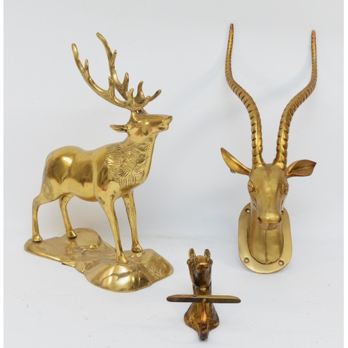 166 - A brass sculpture of a stag, 33cm, a horses head wall hook and an antelope head