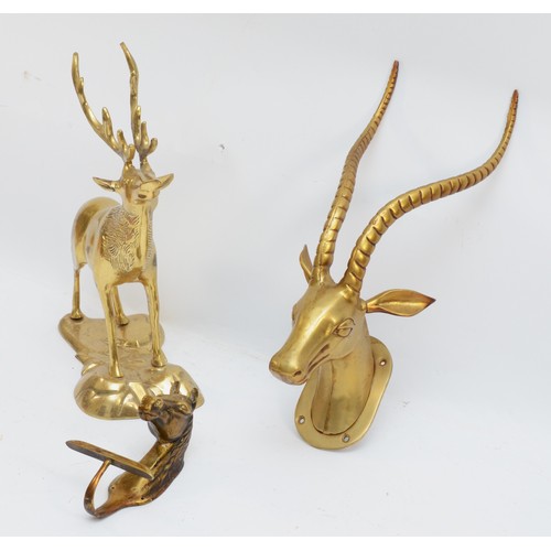 166 - A brass sculpture of a stag, 33cm, a horses head wall hook and an antelope head