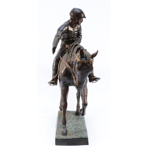 167 - After Mene, a bronze of a racehorse and jockey at a slow trot, raised on cold painted grass base, un... 