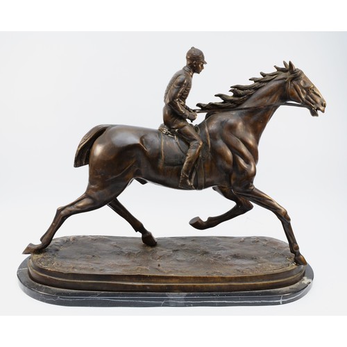 168 - After Mene, a bronze of a racehorse and jockey, on a naturalist base, raised on a marble base, unsig... 