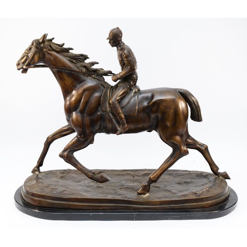 After Mene, a bronze of a racehorse and jockey, on a naturalist base, raised on a marble base, unsigned, 51 x 63cm