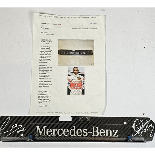 18 - Lewis Hamilton/Mikka Hakkinen, a signed Mercedes Benz carbon fibre engine plate, 44 x 7cm, together ... 