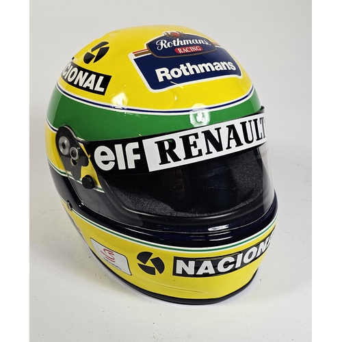 21 - Ayrton Senna, a replica racing helmet, with bag. (2 items)