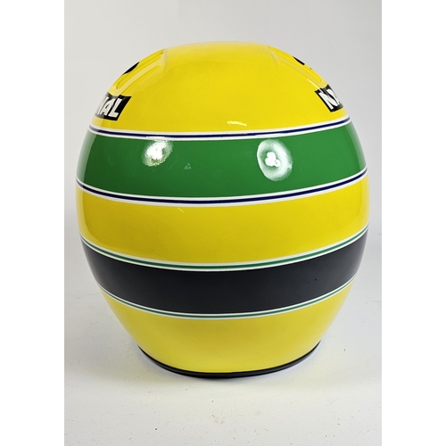 21 - Ayrton Senna, a replica racing helmet, with bag. (2 items)